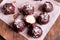 Homemade candies covered with chocolate and shredded coconut