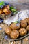 Homemade candies with dates and walnuts on vintage try and wooden background. East sweets for ramadan. Selective focus