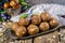 Homemade candies with dates and walnuts on vintage try and wooden background. East sweets for ramadan. Selective focus