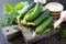 Homemade canned vegetables. Preservation of fresh and pickled cucumbers, garlic and spices on the kitchen table