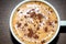 A homemade cappuccino closeup with coco powder on the table