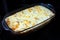 Homemade casserole with meat, vegetables and cheese in the oven.