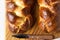 Homemade challah bread or cozonac on a wooden board, light grey stone background. Shabbat, Jewish traditional bread.