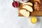 Homemade challah bread or cozonac on a wooden board, light grey stone background. Shabbat, Jewish traditional bread.