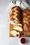 Homemade challah bread or cozonac on a wooden board, light grey stone background. Shabbat, Jewish traditional bread.