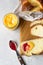 Homemade challah bread or cozonac on a wooden board, light grey stone background. Shabbat, Jewish traditional bread.