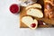 Homemade challah bread or cozonac on a wooden board, light grey stone background. Shabbat, Jewish traditional bread.