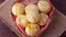 Homemade cheese bread, traditional Brazilian snack, in a heart-shaped basket on a rustic kitchen table