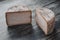 Homemade cheese wheel on the dark wooden background. Top view.