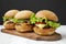 Homemade cheeseburgers on rustic wooden board, side view. Closeup