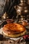 Homemade cheesecake or cottage cheese casserole with berries on rustic wooden table with samovar and teapot, complex composition.