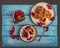 Homemade cheesecakes on two plates with jam and sprigs of red currant, a mug with currant