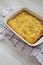 Homemade Cheesy Amish Breakfast Casserole on a white wooden surface, low angle view. Closeup