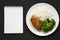 Homemade Chicken Breast, Rice and Broccoli with blank notepad on a black background, top view. Flat lay, overhead, from above