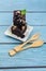 Homemade chocolate brownie on a blue wood background With wooden cutlery , bakery and dessert