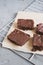 Homemade chocolate brownies served on a paper and tray