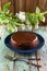 Homemade chocolate cake with chocolate icing in navy blue plate