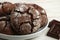 Homemade chocolate cookies with cracks. Biscuits with icing sugar