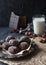 Homemade chocolate crinkles in powdered sugar, chocolate cookies with cracks and a glass of milk