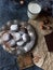 Homemade chocolate crinkles in powdered sugar, chocolate cookies with cracks and a glass of milk