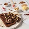Homemade chocolate in mold. Chocolate bar, nuts, freeze dried fruits on white background side view. Chocolatier, confectionery