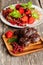 Homemade chocolate muffins with fresh strawberries and currants