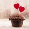 Homemade chocolate muffins with heart, vintage background