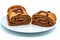 Homemade chocolate roll on plate, isolate on white background. Handmade pastries sprinkled with cocoa. Delicious chocolate-covered