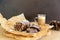 Homemade chocolate sausage on a wooden background. Dessert made of biscuits, chocolate and nuts is sliced on a wooden