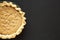 Homemade Chocolate Walnut Derby Pie on a black wooden background, top view. From above, overhead, flat lay. Space for text