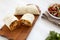 Homemade chorizo breakfast burritos with pico de gallo on a white wooden background, side view. Close-up