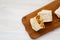 Homemade chorizo breakfast burritos on a rustic wooden board on a white wooden background, top view. Flat lay, overhead, top view