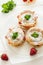 Homemade choux pastry rings with cottage cheese cream and strawberries decorated mint leaves