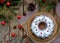 Homemade christmas cake with cranberry and new year tree decorations frame on wooden table background. Rustic style.