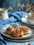 Homemade cinnamon rolls on a gray earthenware tray on blue background