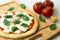 Homemade classic italian napoli pizza with tomato sauce, mozzarella cheese and basil leaves: pizza napoletana.