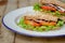 homemade club sandwich with lettuce and tomato
