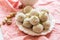 Homemade coconut balls decorated with little pink flowers