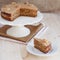 Homemade coffee and walnut cake on a stand with a slice