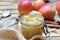 homemade compote  in a glass  jar with red apples  background