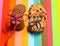 Homemade and consumer cookies on colorful as rainbow background. Comparison of manufactured and homemade cookies, top