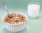 Homemade cooked oatmeal cereals with ceramic mug, metal spoon and glass of milk on blue background
