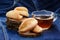 Homemade cookies and black tea on wooden stands on deep blue cloth