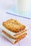 Homemade cookies, muesli bars with glass of milk on a wooden table