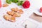 Homemade cookies in shape of heart with I Love you words as gift for lover on Valentine`s day. White wooden table with greeting c