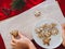 Homemade cookies shaped tree on plate and hand holding Christmas cookies different shapes: star, fir-tree, christmas on