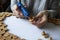 Homemade cork panel, woman makes wine cork note board, selective focus