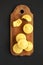 Homemade Cornbread Muffins on a rustic wooden board on a black background, top view. Flat lay, overhead, from above