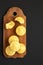 Homemade Cornbread Muffins on a rustic wooden board on a black surface, top view. Flat lay, overhead, from above. Copy space