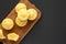 Homemade Cornbread Muffins on a rustic wooden board on a black surface, top view. Flat lay, overhead, from above. Space for text